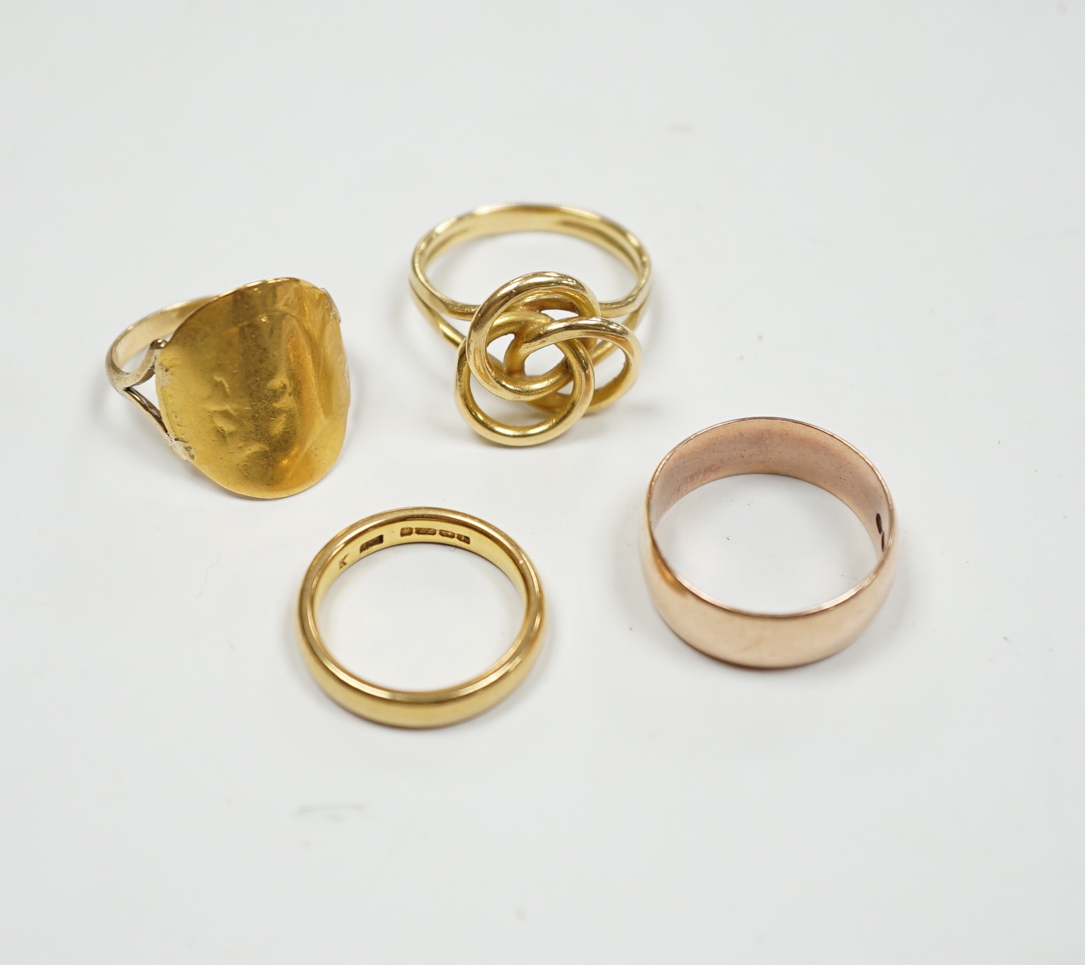 A 1930's 22ct gold wedding band, 5.9 grams, a 9ct gold wedding band, 5.1 grams and two other yellow metal rings, 10.1 grams.